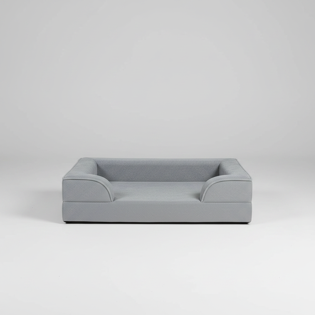 Dog lying on a gray pet bed in a cozy living room.
